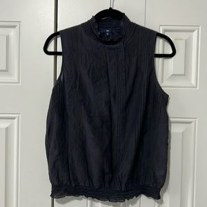 Black sleeveless blouse with button collar and bubble hem